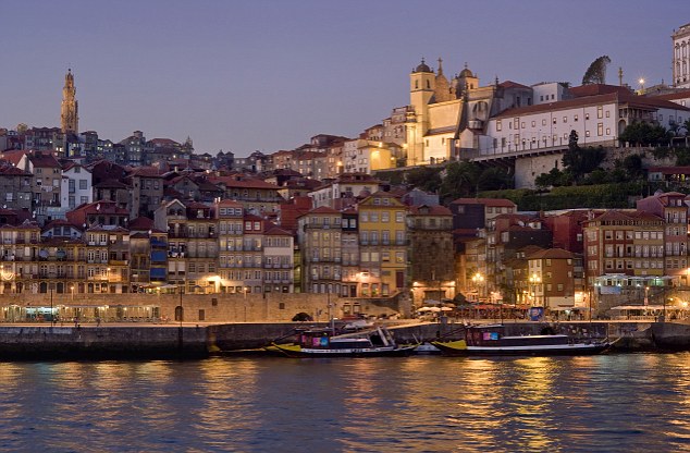 Portugal, Porto, Porto, Oporto, Costa Verde, the Douro river and the Ribeira district of the old town at dusk, the Torre dos Clérigos in the distance